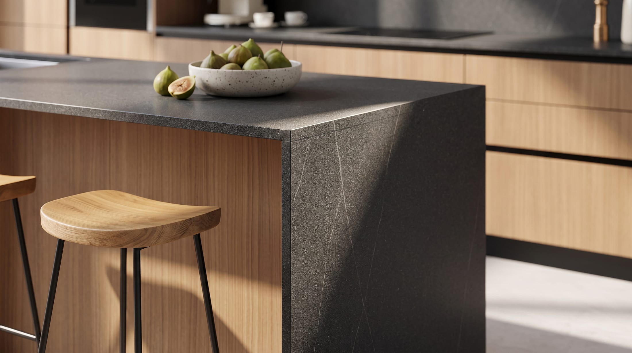 Gacaferi 1957 Stria custom kitchen — black island with a waterfall edge beside an oak stool